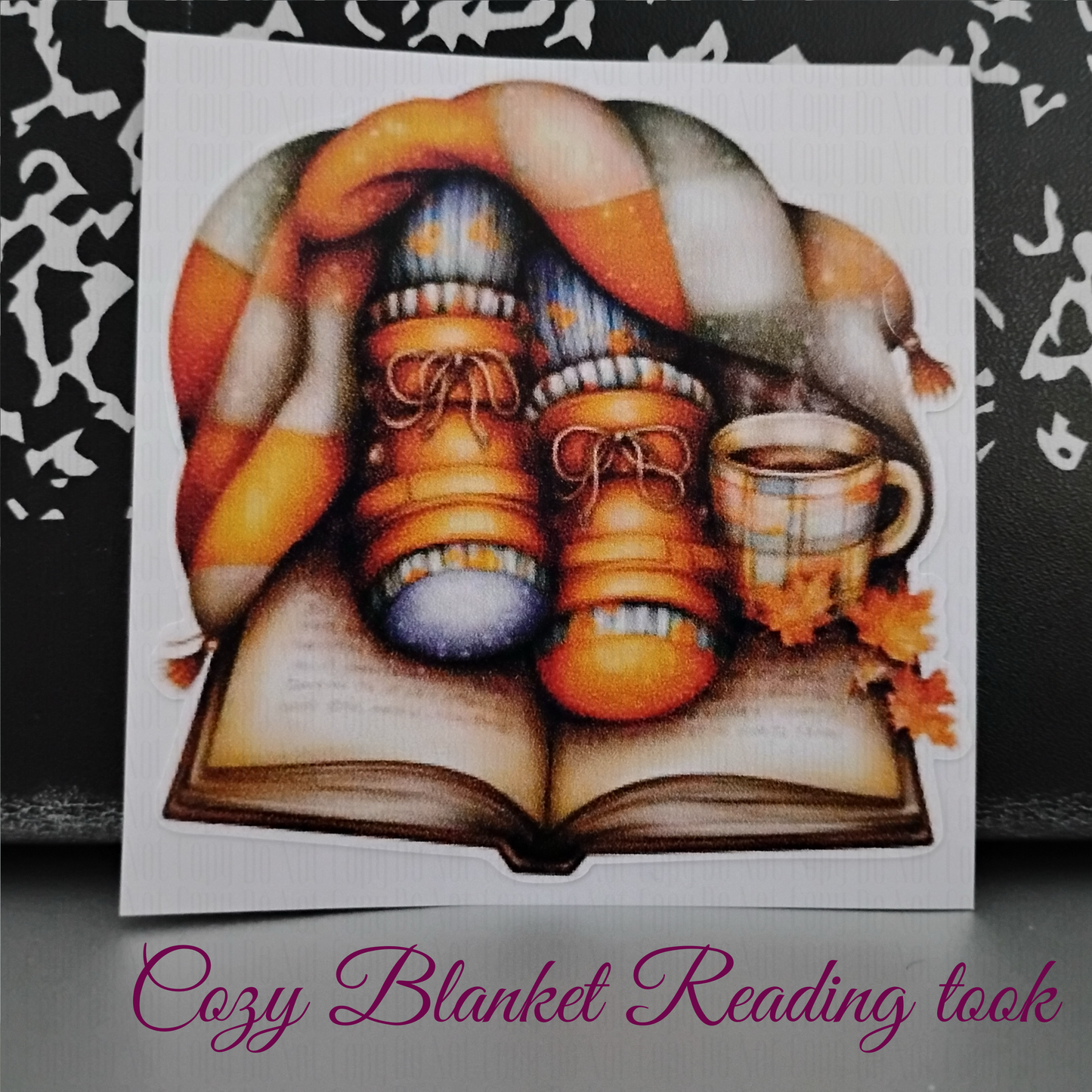 Cozy fall sticker with boots, socks, plaid blanket, open book and coffee mug